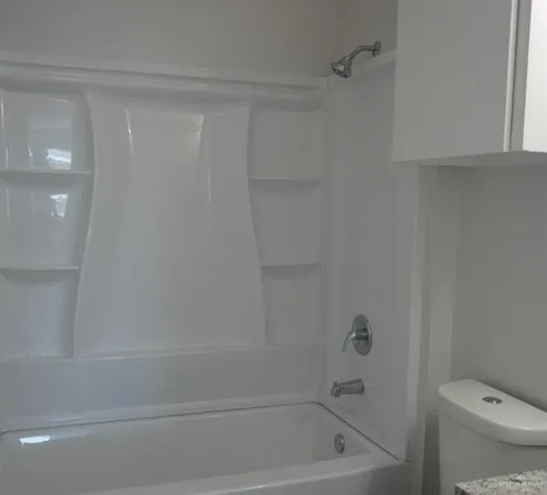 a bathroom with a shower and a toilet