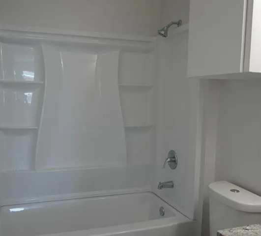 a bathroom with a shower and a toilet