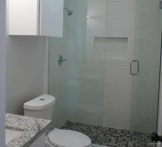 a bathroom with a toilet and a shower