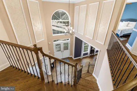 a view of entryway with wooden floor and front door