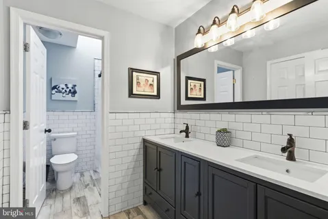 a bathroom with a toilet sink and mirror