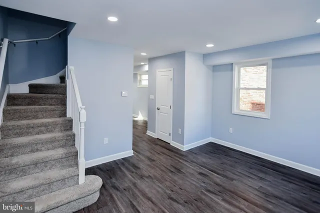 a view of an entryway with wooden floor