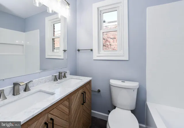 a bathroom with a toilet sink and mirror