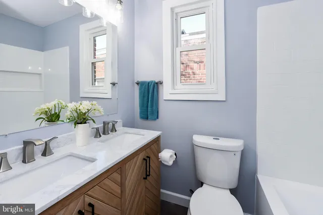 a bathroom with a toilet sink and mirror