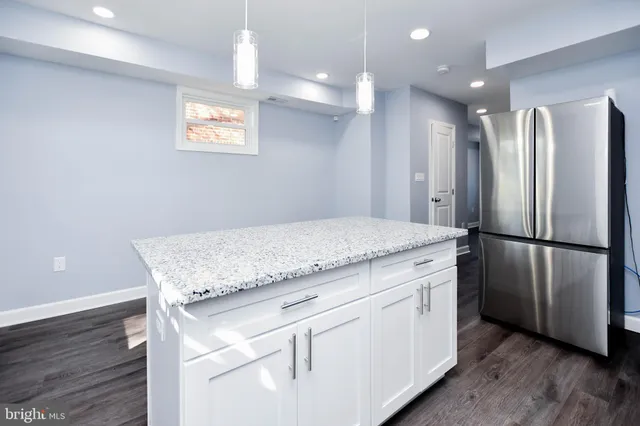 a kitchen with stainless steel appliances granite countertop a refrigerator and a sink
