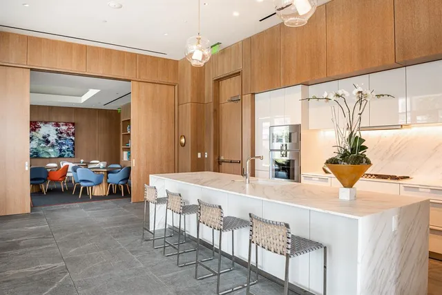 a large kitchen with a table and chairs