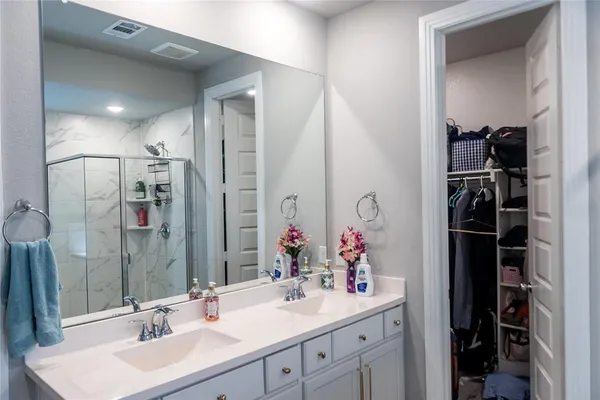a bathroom with a sink vanity and a mirror