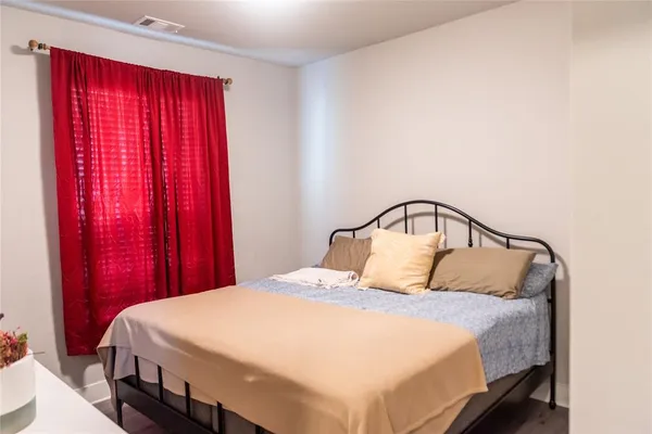 a bedroom with a bed and window