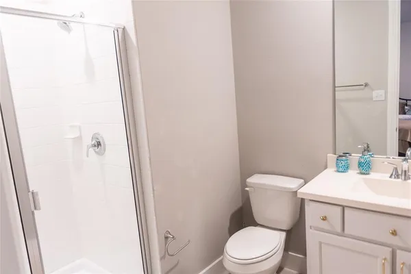 a white toilet sitting next to a bathroom sink