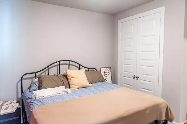 a bedroom with a bed and a mirror