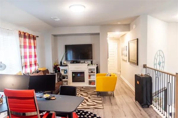 a living room with furniture a flat screen tv and a fireplace