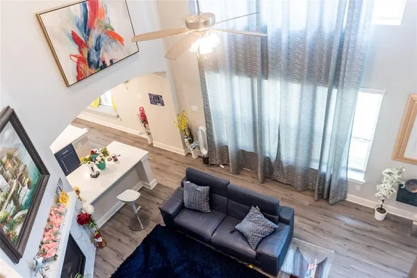 a living room with furniture and a painting on the wall