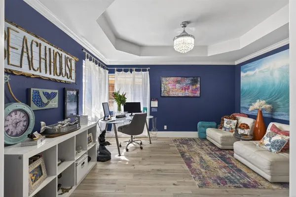 a living room with furniture a clock and a window