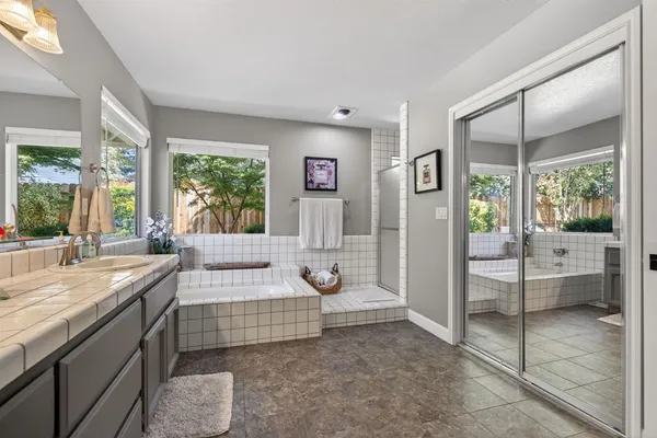 a bedroom with a large bed and a large window