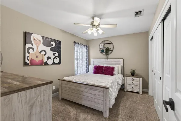 a bedroom with a bed and a chandelier