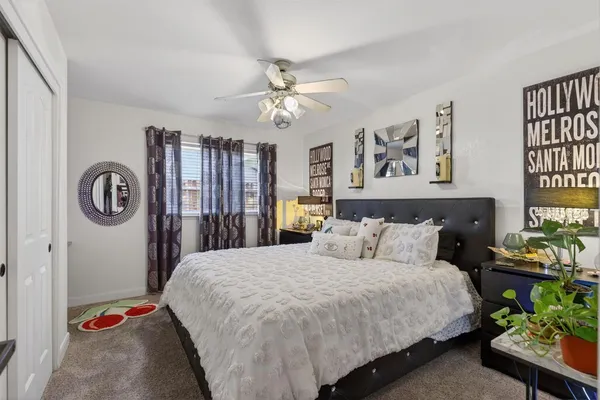 a bedroom with a bed and a chandelier