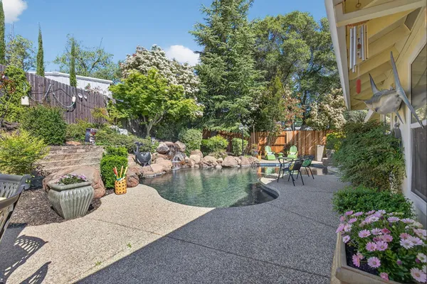 a view of a backyard with sitting area