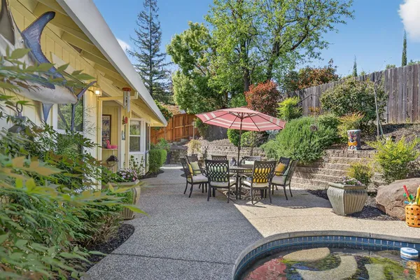 an outdoor space with furniture and umbrella