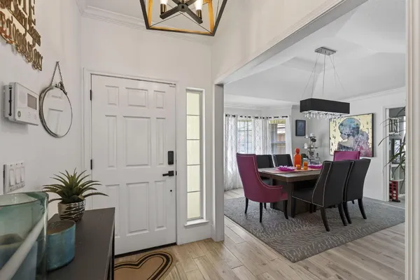 a view of a dining room with furniture and wooden floor