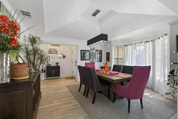 a dining room with furniture window and wooden floor
