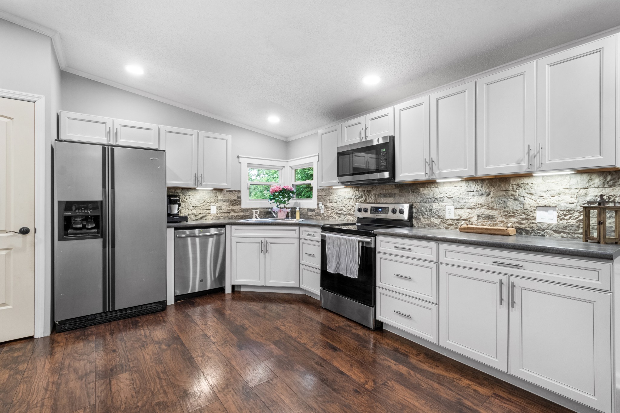 5674 Lakeview Road Springfield, TN 37172 - Photo 34 of 54 a kitchen with white cabinets white stainless steel appliances and sink