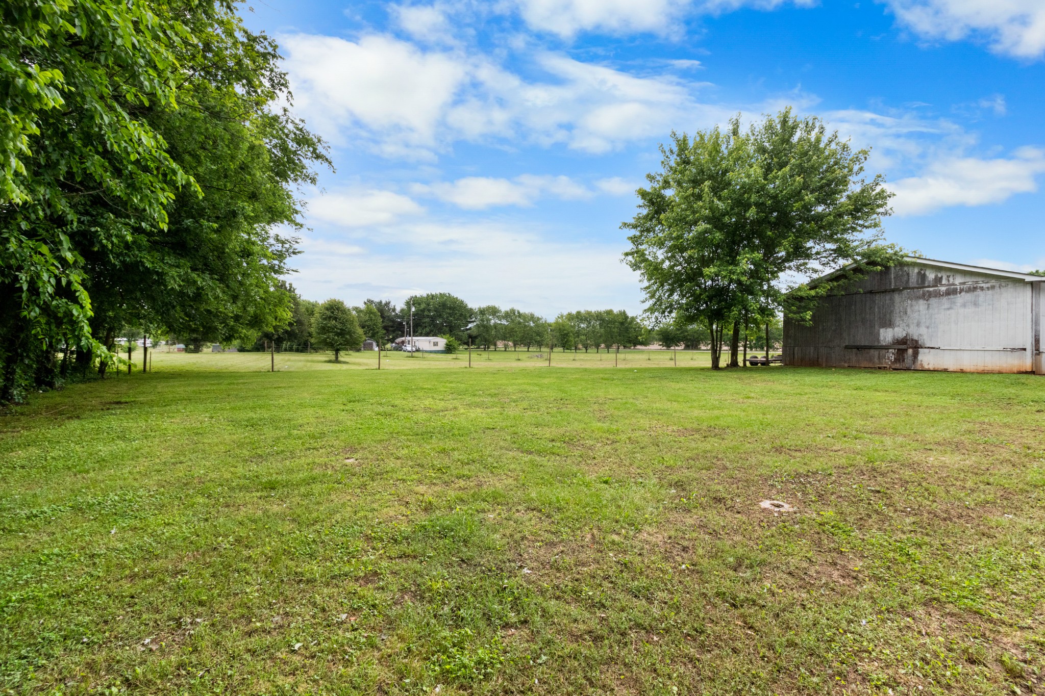 5674 Lakeview Road Springfield, TN 37172 - Photo 49 of 54 a view of a green field with wooden fence