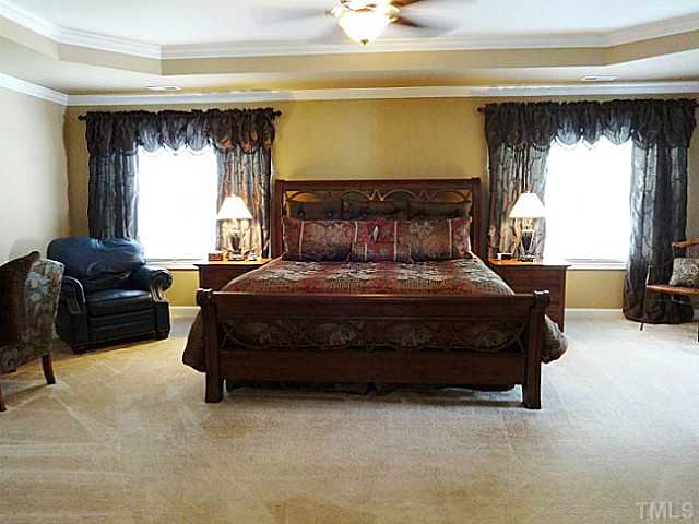 3212 Queensland Road Raleigh, NC 27614 - Photo 10 of 25 Enter the master suite through double doors and find your dream come true. This over sized bedroom features a trey ceiling, two sets of large double windows, and a sitting area.