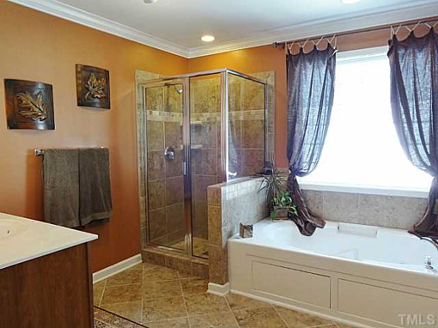3212 Queensland Road Raleigh, NC 27614 - Photo 12 of 25 Enjoy a Calgon moment in this exquisite bathroom spa. Soak in the jetted tub to relieve your troubles. Large tiled separate glass shower for those times when a you are in a rush. Large frosted glass block window allows filtered sunlight in.