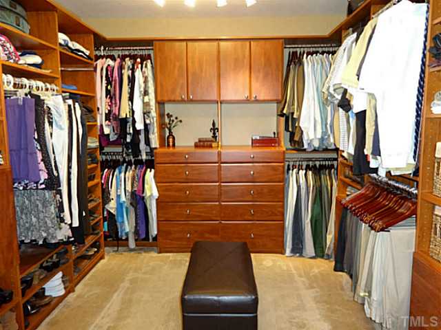 3212 Queensland Road Raleigh, NC 27614 - Photo 14 of 25 Wow! Custom built all wood closet. Plenty of space for his and her clothing. Women don't worry of shoe space. Shelves, cabinets, and drawers provide plenty of storage. This closet has two built in clothes hampers and even a built in ironing board.