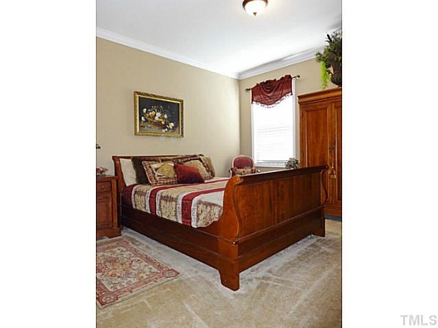 3212 Queensland Road Raleigh, NC 27614 - Photo 19 of 25 Bedroom 5. Located on the main living area, this bedroom can be used as an in-law suite. From this room, you can access a full bathroom. It features crown molding and has a large walk-in closet.