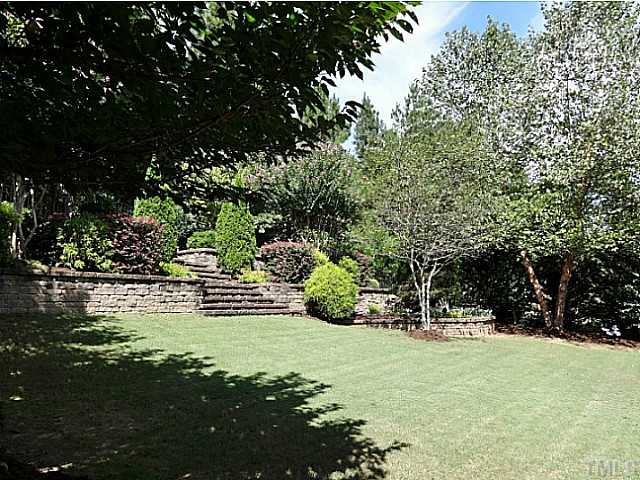 3212 Queensland Road Raleigh, NC 27614 - Photo 23 of 25 This is a magnificent well landscaped private yard. It boast beautiful trees and shrubs for all seasons. The area has electrical landscaping lights on a timer. The terraced brick wall and steps lead to a gate so you can feed the deer or birds.