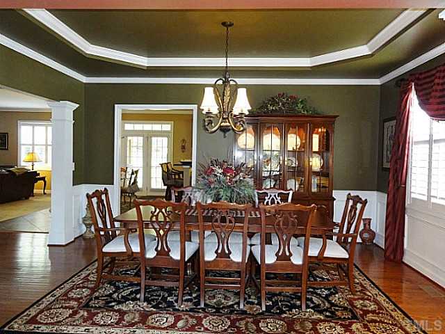 3212 Queensland Road Raleigh, NC 27614 - Photo 5 of 25 Family dinners are easily served in this elegant room. Extra wide door ways flanked by columns, picture frame molding, chair rails, trey ceilings and double windows with plantation blinds make a beautiful backdrop for delicious dinners.