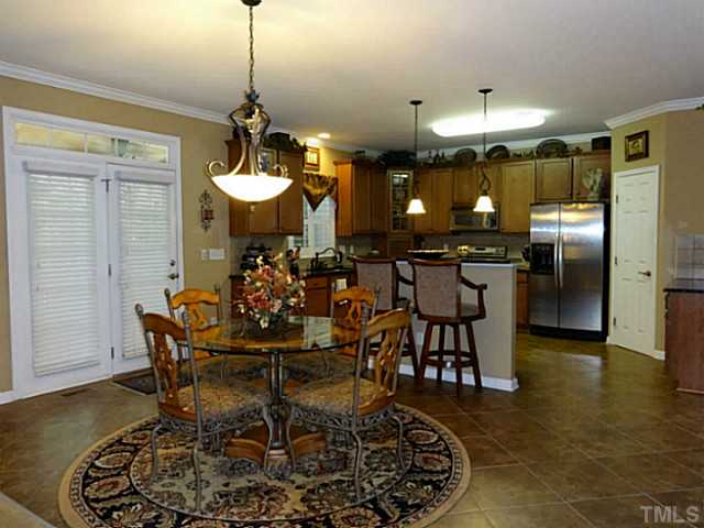 3212 Queensland Road Raleigh, NC 27614 - Photo 7 of 25 Plenty of room in this breakfast area. Tile flooring makes clean up easy in case of spills. The French doors open to the screened porch and breathtaking view of the back yard. The lovely lighting fixtures adds a finish touch to this well planned room.