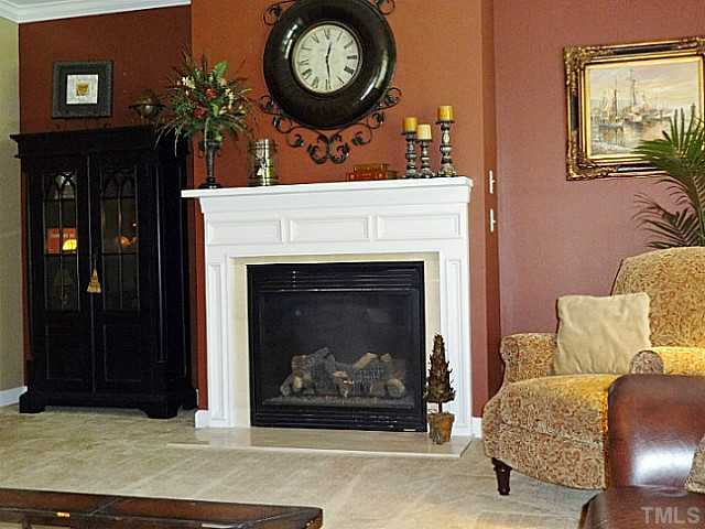3212 Queensland Road Raleigh, NC 27614 - Photo 9 of 25 Grab a book and sit by the gas fireplace and relax. Or spend some quite time gazing out the windows into the backyard. The detailed wood trim and marble hearth are inviting on those cool North Carolina nights. Switches are for both, fireplace and blower.