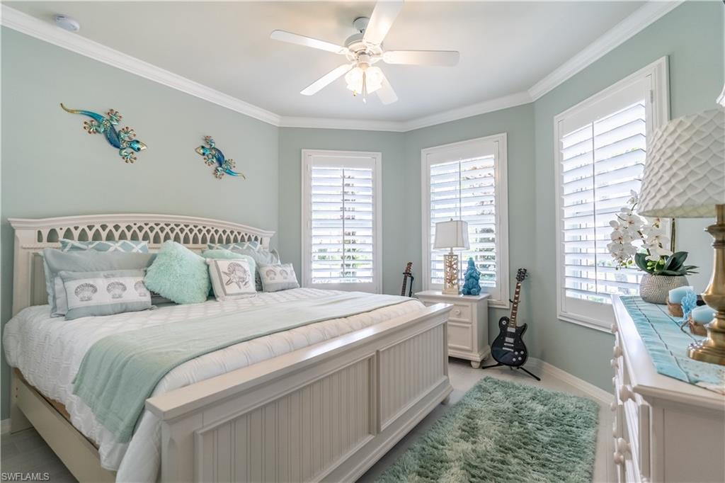 8883 Ravello Court Naples, FL 34114 - Photo 17 of 35 Bedroom with multiple windows, ceiling fan, and ornamental molding