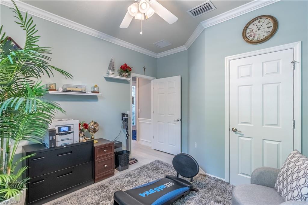 8883 Ravello Court Naples, FL 34114 - Photo 18 of 35 Living area with ornamental molding, light hardwood / wood-style flooring, and ceiling fan