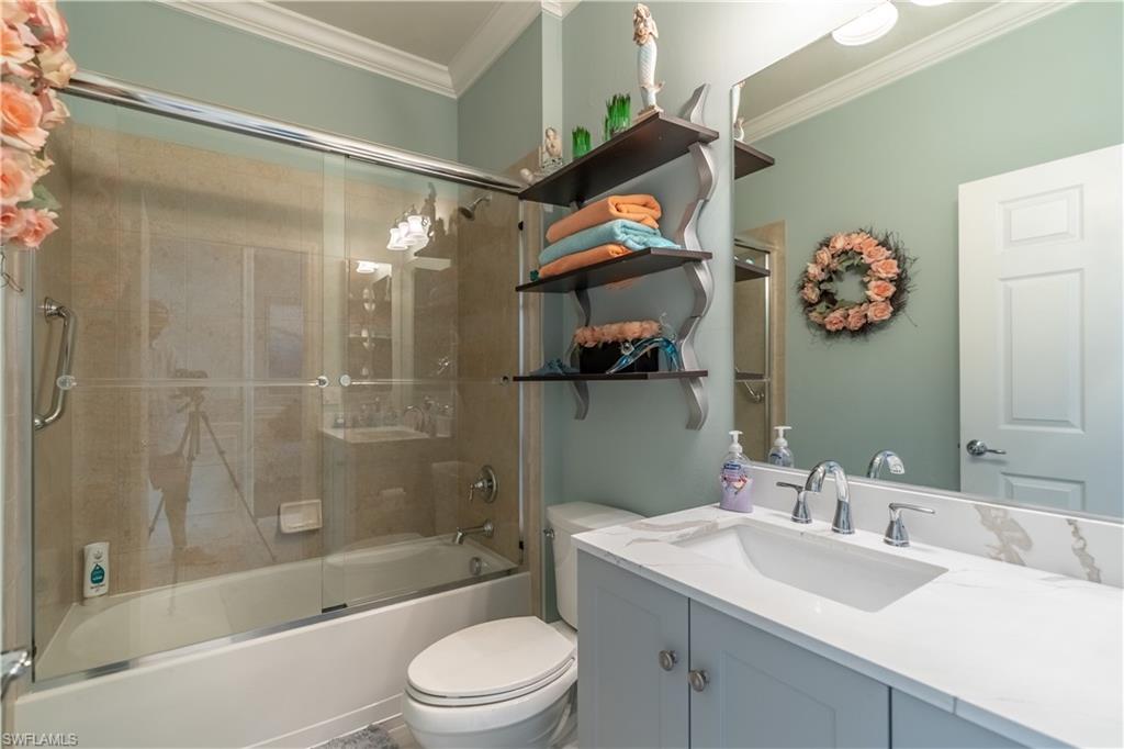 8883 Ravello Court Naples, FL 34114 - Photo 19 of 35 Full bathroom with combined bath / shower with glass door, toilet, vanity, and ornamental molding