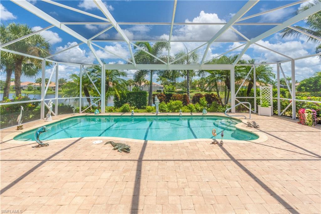 8883 Ravello Court Naples, FL 34114 - Photo 27 of 35 View of swimming pool with glass enclosure and a patio area