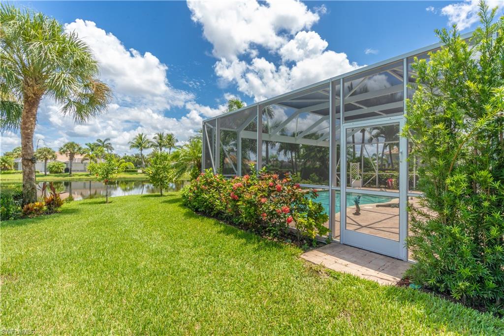 8883 Ravello Court Naples, FL 34114 - Photo 31 of 35 View of yard featuring a water view and a lanai