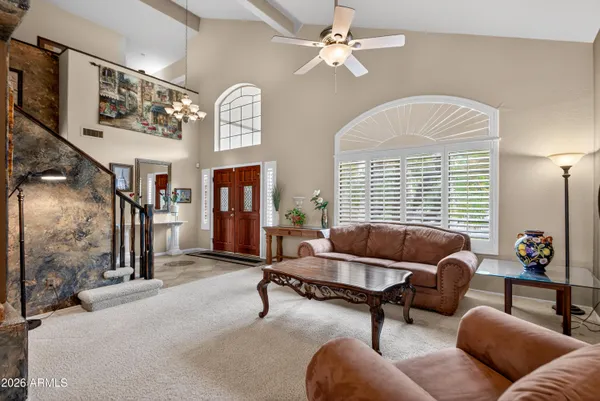 a view of a dining room with furniture wooden floor and a chandelier