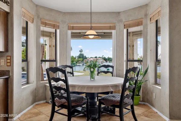 a kitchen with granite countertop a stove a sink a oven and a large window