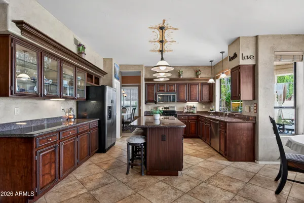 a spacious bedroom with a large bed and a chandelier