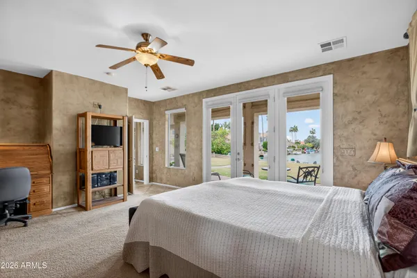 a bedroom with a large bed and a chandelier