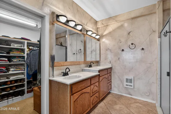 a bathroom with a granite countertop sink mirror and a bathtub