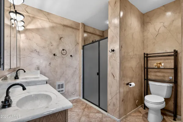 a bathroom with a sink a potted plant and a window