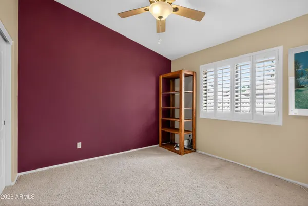 a view of a backyard with potted plants and large trees