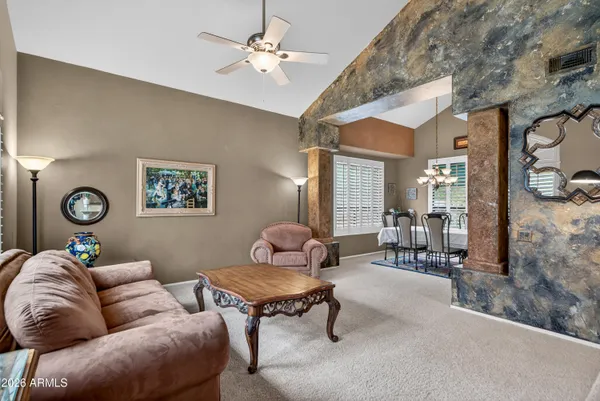 a living room with furniture a rug and a large window