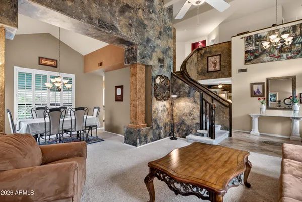 a living room with furniture ceiling fan and a window