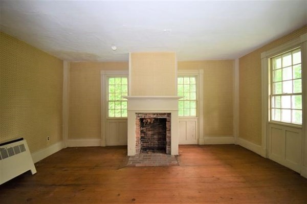 8 Old Coach Road Kingston, NH 03848 - Photo 11 of 27 an empty room with windows and fireplace