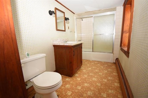8 Old Coach Road Kingston, NH 03848 - Photo 24 of 27 a bathroom with a granite countertop toilet sink and mirror